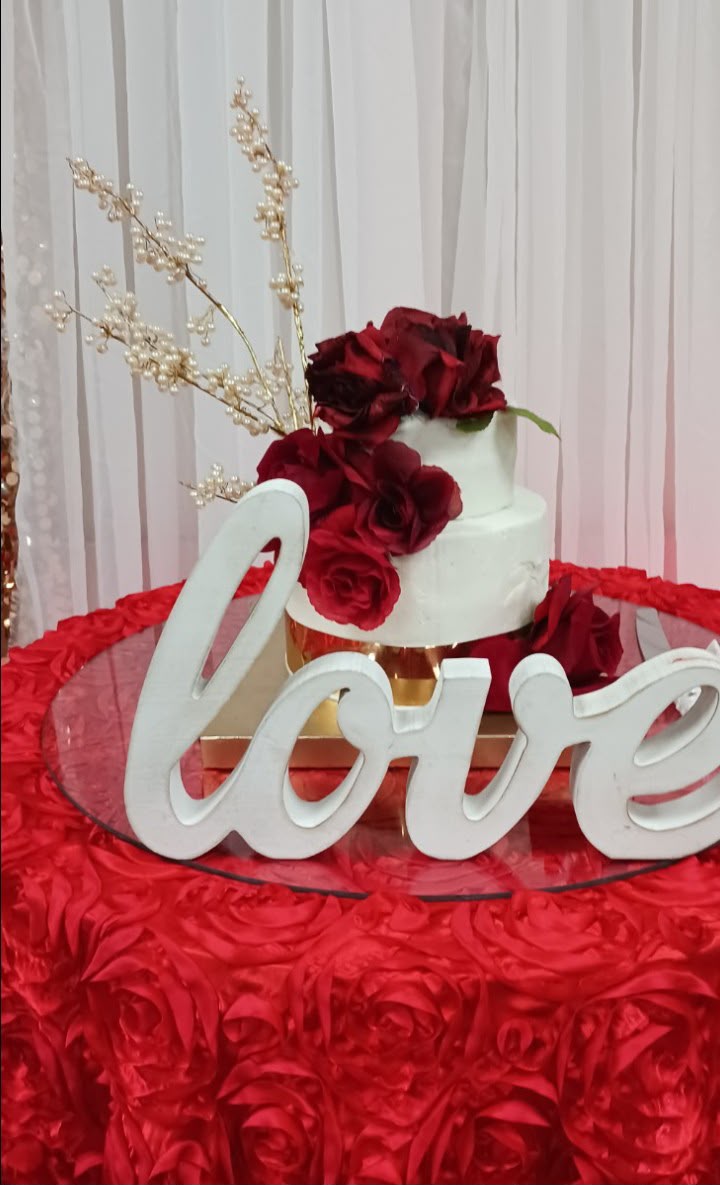 Birthday celebration table styled with florals, cake, and candles