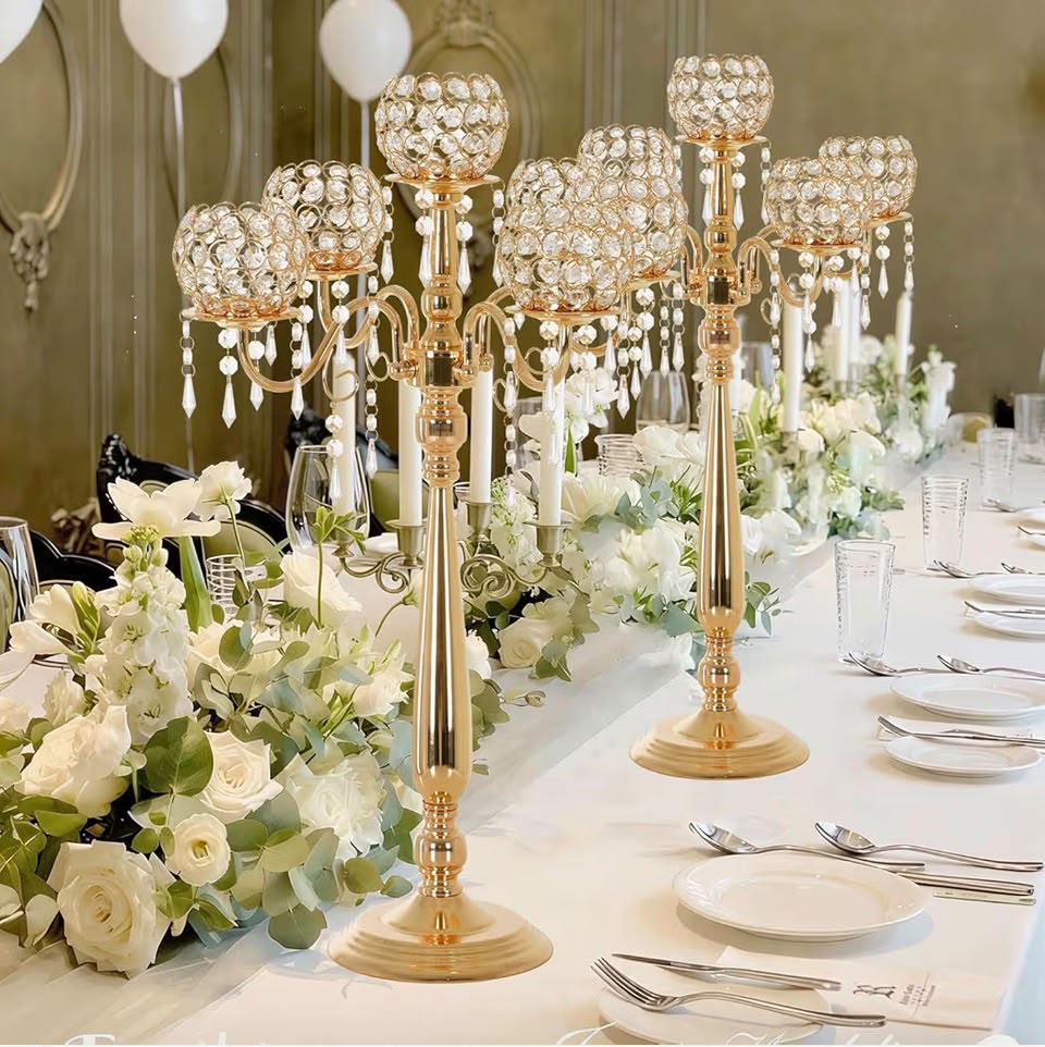 Stylist arranging a luxury floral centerpiece on an ivory tablescape